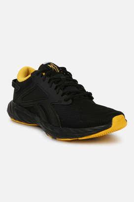 Black and yellow store reebok shoes